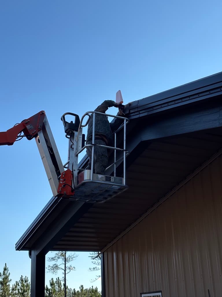 Hi-boost antenna installation on roofline via boom lift