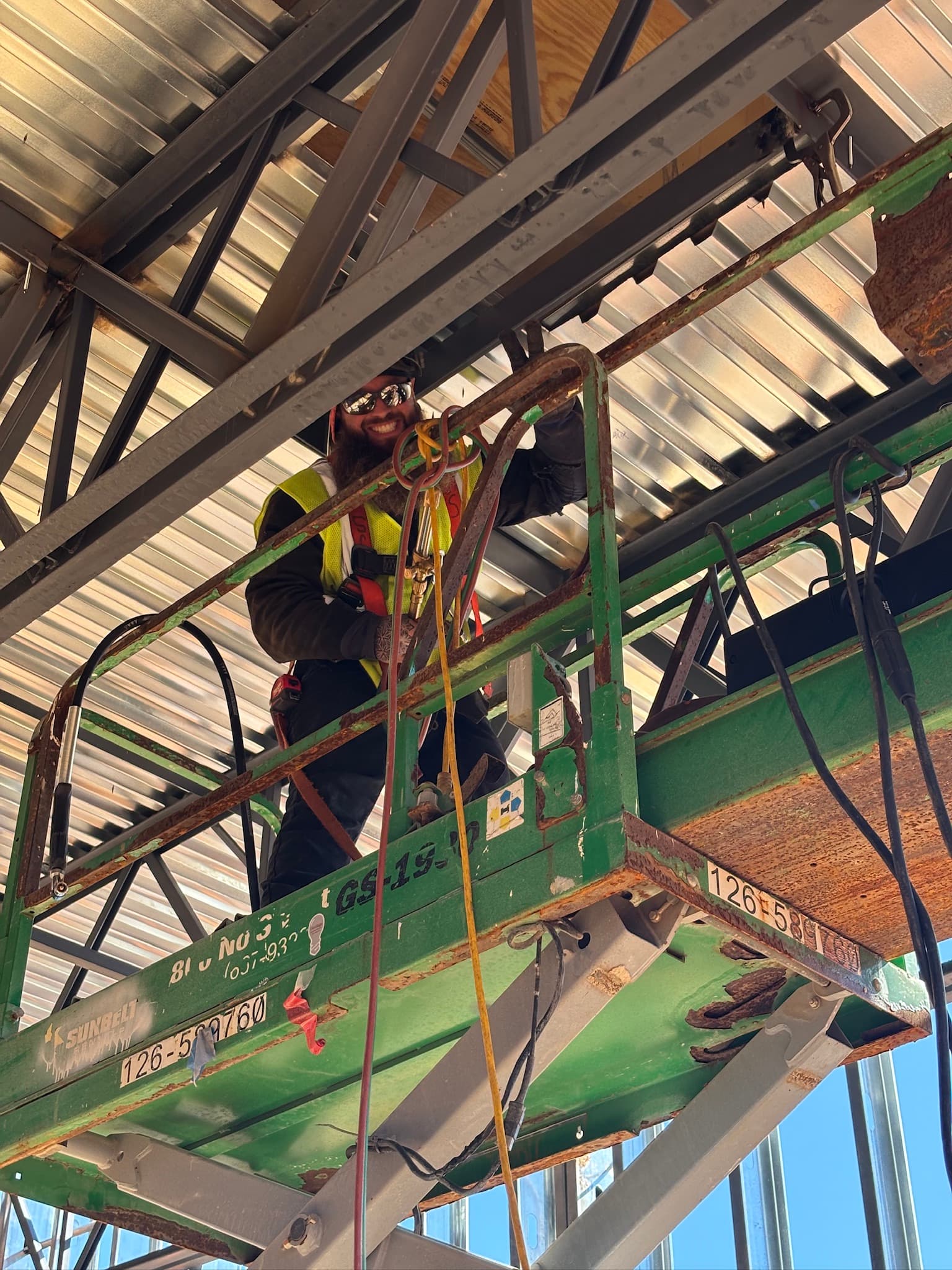DJN crew on scissor lift inside commercial build